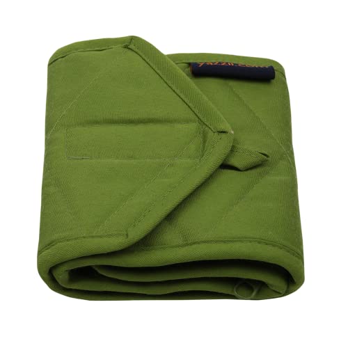 a green bag sitting on top of a green blanket 